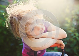 Closeup photo of a dreaming little girl outdoor