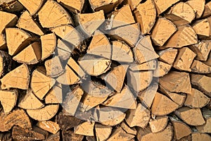 Closeup photo of dry logs stacked in rows. The structure of the tree. Decorative wooden layout