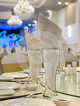Closeup photo of elegant banquet table setting in wedding hall