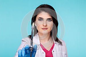 Closeup photo of female dentist in blue gloves with dental acus isolated over the blue backgrownd.