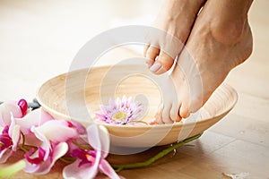 Closeup photo of a female feet at spa salon on pedicure procedure