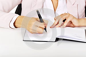 Closeup photo of female hand writing notes