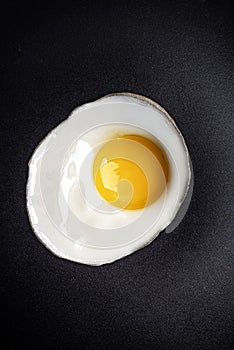 Closeup photo of fried egg on the pan surface