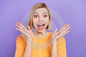 Closeup photo of funny excited young girl open mouth raise arms overjoyed wear t-shirt isolated purple color background