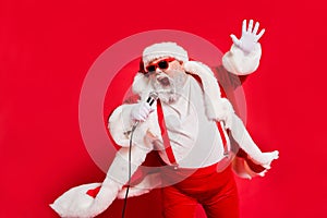 Closeup photo of funny funky wild vocalist screaming in microphone wearing fur coat gloves suspenders isolated bright