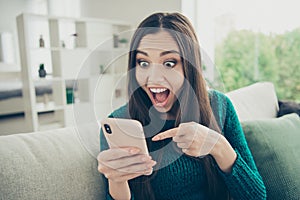 Closeup photo of funny with humorous facial emotional expression demonstrating forefinger on telephone sms message