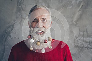 Closeup photo of funny white haired old man with colorful toy balls in long beard decorations wear stylish red pullover