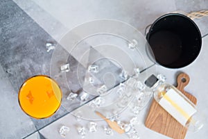 Closeup photo of a glass of fresh orange juice with ice cubes