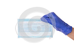 Closeup photo of hand in latex glove holding one medical mask isolated over white color cutout background