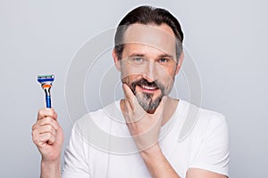 Closeup photo of handsome mature handsome man looking mirror use razor going to shave beard metrosexual neat guy wear