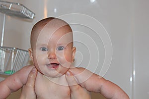 A closeup photo of happy baby smiling after bath time