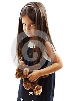 Closeup photo of little girl shows her furrowed brow and irritated frown