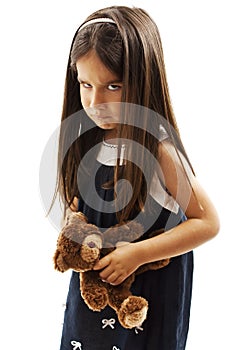 Closeup photo of little girl shows her furrowed brow and irritated frown photo