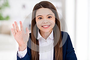 Closeup photo of little pretty cheerful student school girl sitting desk social distancing quarantine continue studying