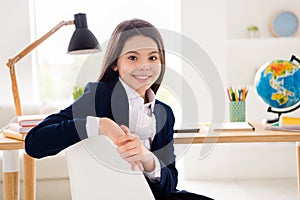 Closeup photo of little pretty student girl good mood return school online way learning sitting comfy chair table desk