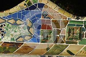 Closeup photo with a long mosaic serpentine bench in the Parc Guell in Barcelona, Spain
