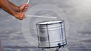 Closeup photo of male musician playing on drum with sticks
