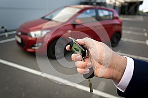 Closeup photo of man opening car with remote alarm key