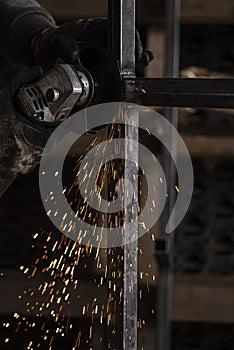 Closeup photo of metalworking in dark workshop