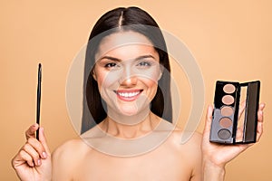 Closeup photo of nude mature latin lady holding tone complexion palette applicator going to make morning makeup looking