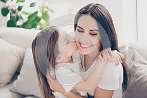 Closeup photo of pretty little girl kissing cheek young charming attractive mommy hugging holding each other close