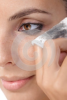 Closeup photo of removing eye makeup