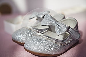 Closeup photo of the shiny shoes of little girl for celebration