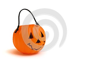 A plastic Halloween cup in the shape of a pumpkin with a face features