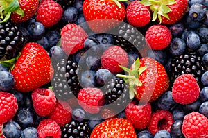 Closeup photo of wild berries strawberries, raspberries, blackberries, blueberries