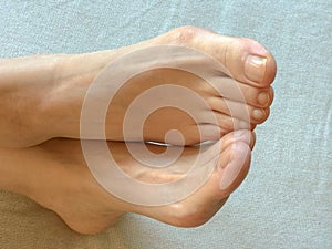 Closeup photo of woman cross feet and toes