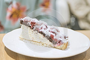 woman eating piece of cake with raspberries