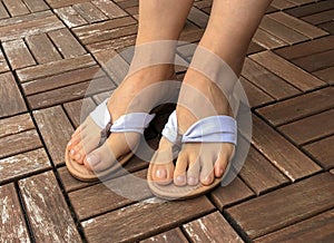 Closeup photo of woman feet in fashion flip flop