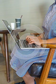 Closeup photo of woman hand typing laptop keyboard