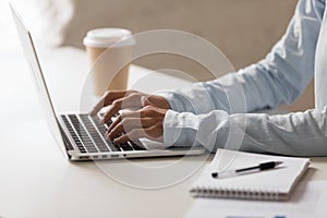 Closeup photo of woman hands typing on notebook at desktop photo