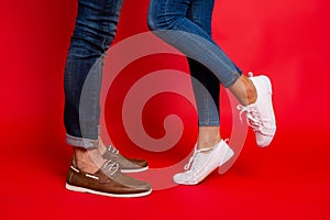 Closeup photo of woman and man legs in jeans, pants and shoes, g