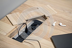 Closeup photo of wooden table with power sockets