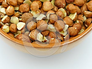 Ceramic bowl filled with hazelnuts cores photo