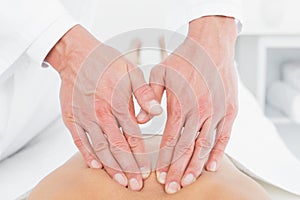 Closeup of a physiotherapist massaging womans back