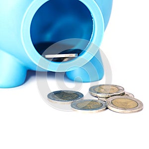 Closeup piggy bank with coins on white isolated background
