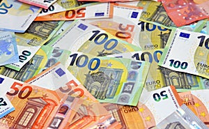 Closeup of a pile of 100 and 50 euro banknotes