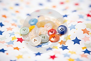 closeup of pile of colorful buttons on white fabric