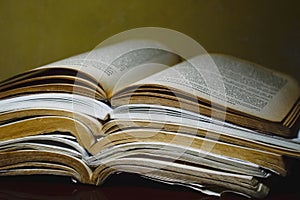 Closeup of a pile of opened books.  Knowledge, wisdom, information, learning concept