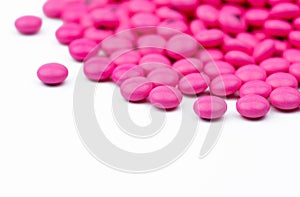 Closeup pile of pink round sugar coated tablets pills isolated on white background with copy space. Amitriptyline medicine