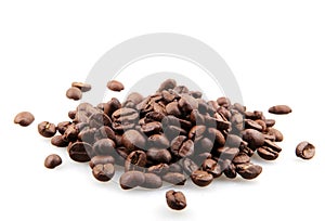 Closeup of a pile of roasted coffee beans isolated on a white background