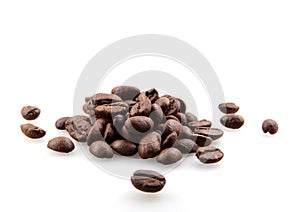 Closeup of a pile of roasted coffee beans isolated on a white background