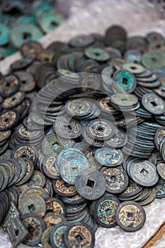 A closeup of a pile of rusty ancient Chinese coins