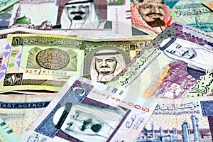 Closeup of a pile of Saudi Arabia riyals money bills of different values from different times