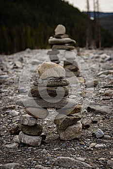 Closeup of pile of stones on a rocky road near a fir forest