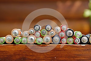 Closeup of pile of used alkaline batteries. Alkaline battery aa size. Several batteries in rows.