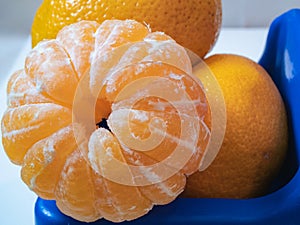 Closeup of pilled mandarine on a top of a pile